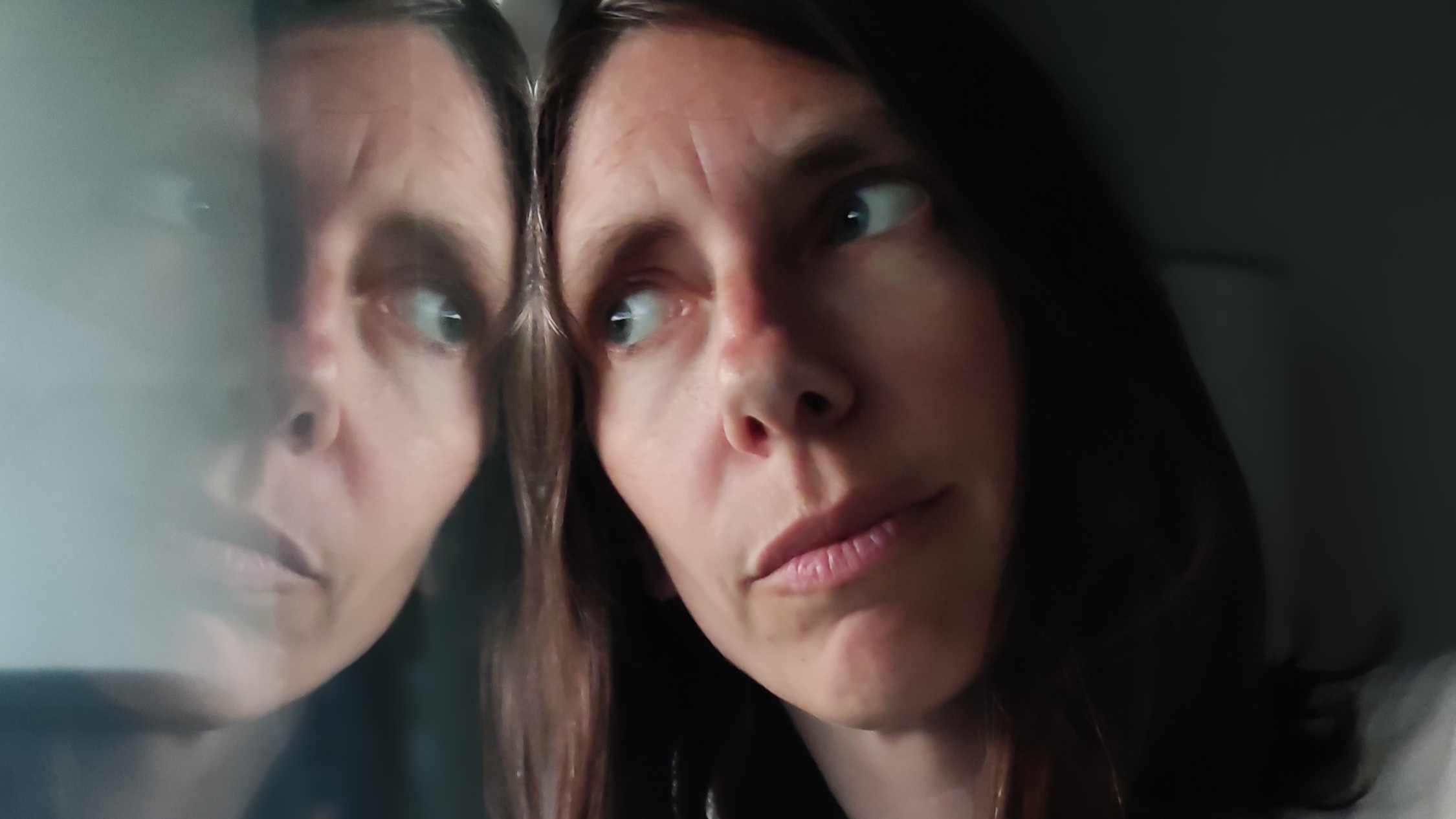 Woman staring in mirror